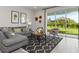 Inviting living room with a gray sofa, modern rug, and sliding glass doors to the backyard at 4409 Lions Gate Ave, Clermont, FL 34711