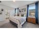 Cozy main bedroom featuring calming decor, large windows with curtains, and an en-suite bathroom at 4409 Lions Gate Ave, Clermont, FL 34711