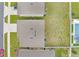 Birds-eye view displaying the roofs of several properties, green lawns, and a nearby pool at 4644 Bernard Blvd, Haines City, FL 33844