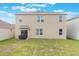 View of the home's backyard with grassy area and partial view of the exterior with covered patio at 4644 Bernard Blvd, Haines City, FL 33844