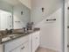 Bright bathroom featuring a granite vanity top, a mirror and a modern sink at 4644 Bernard Blvd, Haines City, FL 33844