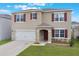 Inviting two-story home featuring a well-maintained lawn and a two-car garage at 4644 Bernard Blvd, Haines City, FL 33844