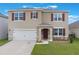 Inviting two-story home featuring a well-maintained lawn and a two-car garage at 4644 Bernard Blvd, Haines City, FL 33844