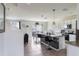 Bright, modern kitchen with granite countertops, stainless steel appliances, tile flooring, and a large island with bar seating at 4644 Bernard Blvd, Haines City, FL 33844