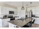 Spacious kitchen featuring white cabinets, stainless steel appliances, granite countertops, and a large island with seating at 4644 Bernard Blvd, Haines City, FL 33844