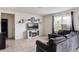 Bright living room featuring an electric fireplace, wall decor, and a plush grey sofa at 4644 Bernard Blvd, Haines City, FL 33844