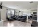 Inviting living area with an oversized grey sectional, seamlessly connected to the kitchen at 4644 Bernard Blvd, Haines City, FL 33844