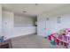 Open loft area perfect as a playroom, featuring neutral carpet and natural lighting at 4644 Bernard Blvd, Haines City, FL 33844