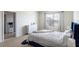 Bright main bedroom with an ensuite bathroom, featuring neutral decor, carpet, and a bright window at 4644 Bernard Blvd, Haines City, FL 33844