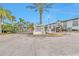 Millennium Palms Condominiums entrance featuring a gated entry, attractive landscaping and unit exteriors at 4701 S Texas Ave # 4701A, Orlando, FL 32839