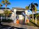 Welcoming condominium entrance with covered walkway, mature palm trees and bright landscaping at 4701 S Texas Ave # 4701A, Orlando, FL 32839