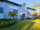 Two-story condominium exterior featuring light blue paint and lush landscaping at 4701 S Texas Ave # 4701A, Orlando, FL 32839