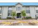 Two-story condominium exterior featuring light grey paint and an entrance with stairs at 4701 S Texas Ave # 4701A, Orlando, FL 32839