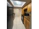 Kitchen featuring matching cabinets, granite countertops and black appliances at 4701 S Texas Ave # 4701A, Orlando, FL 32839