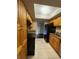 Kitchen featuring matching cabinets, granite countertops, tile floors and black appliances at 4701 S Texas Ave # 4701A, Orlando, FL 32839