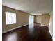 An open living room with wood-look floors, neutral walls, natural light, and a sliding glass door to the outside at 4701 S Texas Ave # 4701A, Orlando, FL 32839