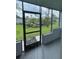 Enclosed patio featuring screened windows and views of the community landscaping at 4701 S Texas Ave # 4701A, Orlando, FL 32839