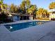 Community pool featuring a covered seating area and nearby palm trees and unit exteriors at 4701 S Texas Ave # 4701A, Orlando, FL 32839