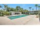 Community pool featuring a covered seating area and nearby palm trees and unit exteriors at 4701 S Texas Ave # 4701A, Orlando, FL 32839