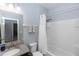 Secondary bathroom with vanity, granite countertop, bath tub, white curtain, and a shower combo at 4733 Cliveden Loop, Sanford, FL 32773