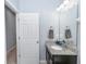 Half bathroom with a vanity featuring granite countertop, cabinets, faucet, and a mirror at 4733 Cliveden Loop, Sanford, FL 32773