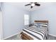 Comfortable guest bedroom featuring a wooden bed, ceiling fan and window at 4733 Cliveden Loop, Sanford, FL 32773