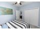 Guest bedroom with map wall decor, ceiling fan and closet with mirrored doors at 4733 Cliveden Loop, Sanford, FL 32773