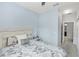 Cozy guest bedroom with grey and white bedding and neutral-colored walls at 4733 Cliveden Loop, Sanford, FL 32773