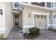 Home's inviting entrance with a brick-paved walkway, featuring a well-maintained front garden and exterior lighting at 4733 Cliveden Loop, Sanford, FL 32773