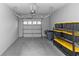 Clean two-car garage with epoxy flooring and ample storage space, showcasing functionality and organization at 4733 Cliveden Loop, Sanford, FL 32773