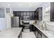 Modern kitchen with stainless steel appliances, granite countertops and dark wood cabinetry at 4733 Cliveden Loop, Sanford, FL 32773