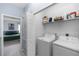 Convenient laundry room with washer, dryer, shelving and storage space at 4733 Cliveden Loop, Sanford, FL 32773