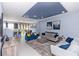 A bright living room with modern decor and an open floor plan that connects the dining area and kitchen at 4733 Cliveden Loop, Sanford, FL 32773