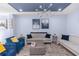 A stylish living room featuring comfortable seating, a unique light fixture, and eye-catching wall art at 4733 Cliveden Loop, Sanford, FL 32773