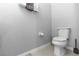 A simple, white powder room with light tile floors with a pedestal sink and classic toilet at 4733 Cliveden Loop, Sanford, FL 32773