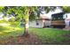 Backyard with lush green grass and a screened lanai visible at 4905 Newton Ct, St Cloud, FL 34771