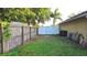 Fenced backyard featuring a white double gate and ample lawn space at 4905 Newton Ct, St Cloud, FL 34771