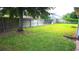 Backyard featuring a wooden fence and a large tree providing shade at 4905 Newton Ct, St Cloud, FL 34771