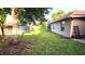 Lawn in fenced backyard featuring green grass and a screen porch at 4905 Newton Ct, St Cloud, FL 34771