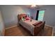 Cozy bedroom with a neutral color scheme, wood-look floors, and natural light at 4905 Newton Ct, St Cloud, FL 34771