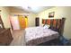 Spacious bedroom with wooden headboard, barn door to closet, and wood-look flooring at 4905 Newton Ct, St Cloud, FL 34771