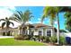 Charming home exterior with tropical landscaping and manicured lawn at 4905 Newton Ct, St Cloud, FL 34771