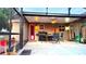 Covered outdoor patio with a ceiling fan, grill, and dining furniture at 4905 Newton Ct, St Cloud, FL 34771
