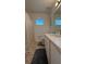 Bright bathroom features a shower-tub combo and a clean, modern white vanity at 513 Bailey Cir, Davenport, FL 33897