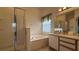 Bathroom featuring a large tub, a glass enclosed shower, and vanity with countertop at 513 Bailey Cir, Davenport, FL 33897