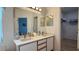 Bathroom featuring double sinks, quartz countertops, and modern fixtures at 513 Bailey Cir, Davenport, FL 33897