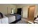 Relaxing bedroom with a comfortable bed, wood floors, and an en-suite bathroom at 513 Bailey Cir, Davenport, FL 33897