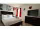 Well-decorated bedroom boasts a television, dark dresser, and natural lighting at 513 Bailey Cir, Davenport, FL 33897