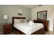 Comfortable bedroom features a queen-size bed, soft linens, and a classic wooden dresser at 513 Bailey Cir, Davenport, FL 33897