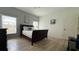 Bedroom with hard wood floors, white walls, a ceiling fan, and two windows with blinds at 513 Bailey Cir, Davenport, FL 33897